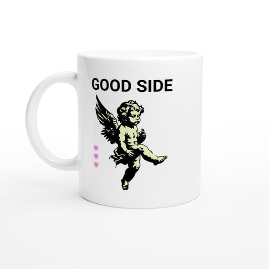 White ceramic mug showing illustration of cute cupid with lovehearts and the words good side