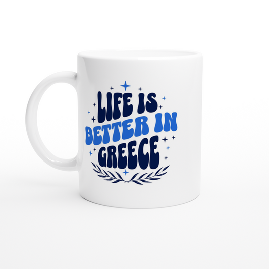 White mug with blue writing with life is better in Greece stars decoration and olive wreath