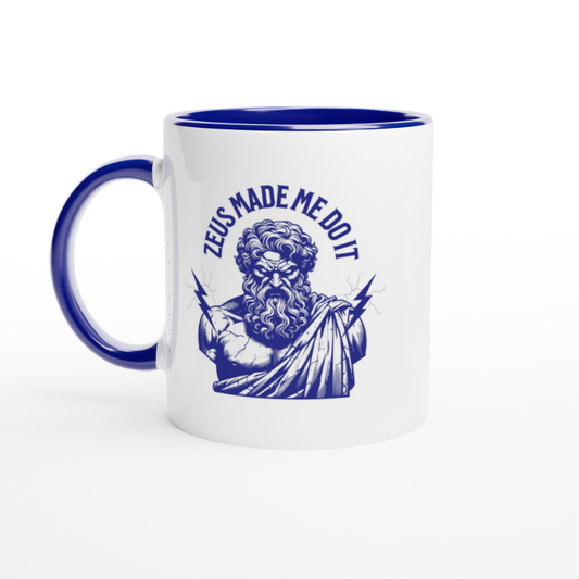 White mug with blue handle and interior with blue Zeus Made Me Do It Text illustration of the greek god Zeus with lightning bolts looking angry
